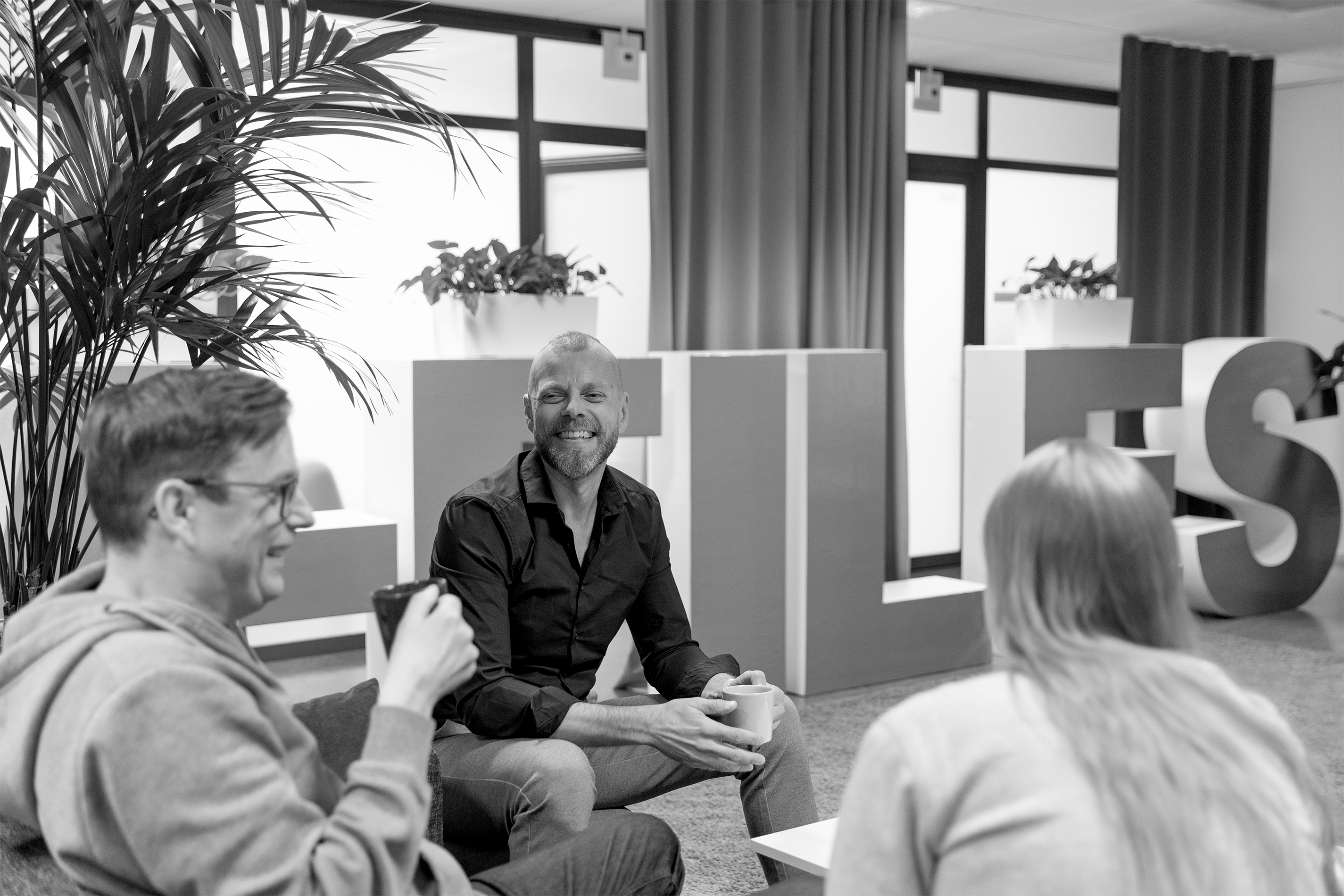 M-Files Staff-Group-sitting-laughing